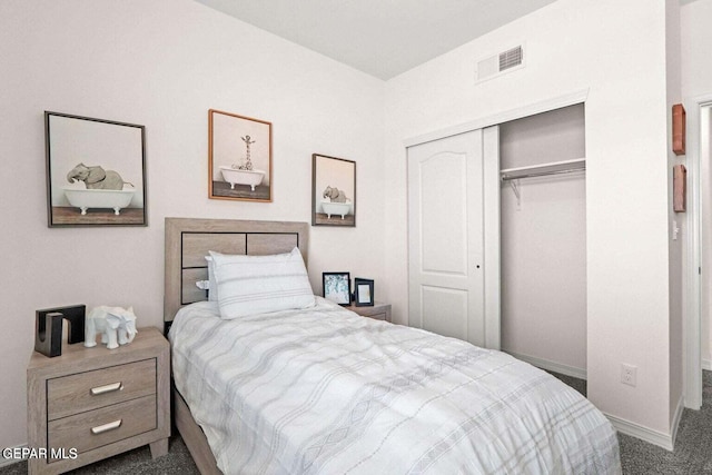 carpeted bedroom with a closet, visible vents, and baseboards