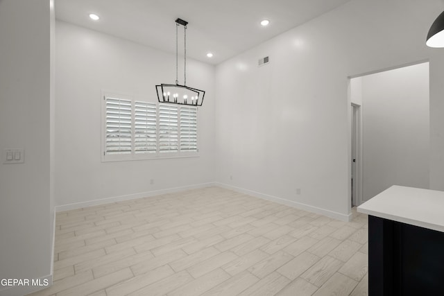 unfurnished dining area featuring recessed lighting, visible vents, an inviting chandelier, and light wood-style flooring