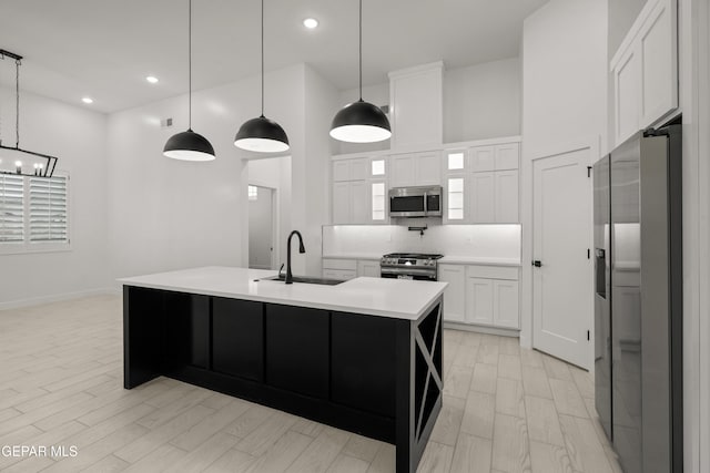 kitchen with backsplash, light countertops, an inviting chandelier, stainless steel appliances, and a sink