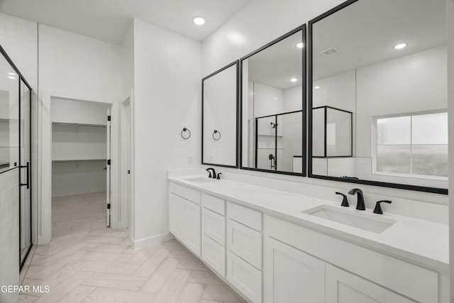 full bathroom featuring visible vents, double vanity, recessed lighting, a sink, and a shower stall