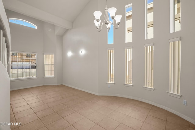 tiled spare room with high vaulted ceiling, beamed ceiling, baseboards, and an inviting chandelier