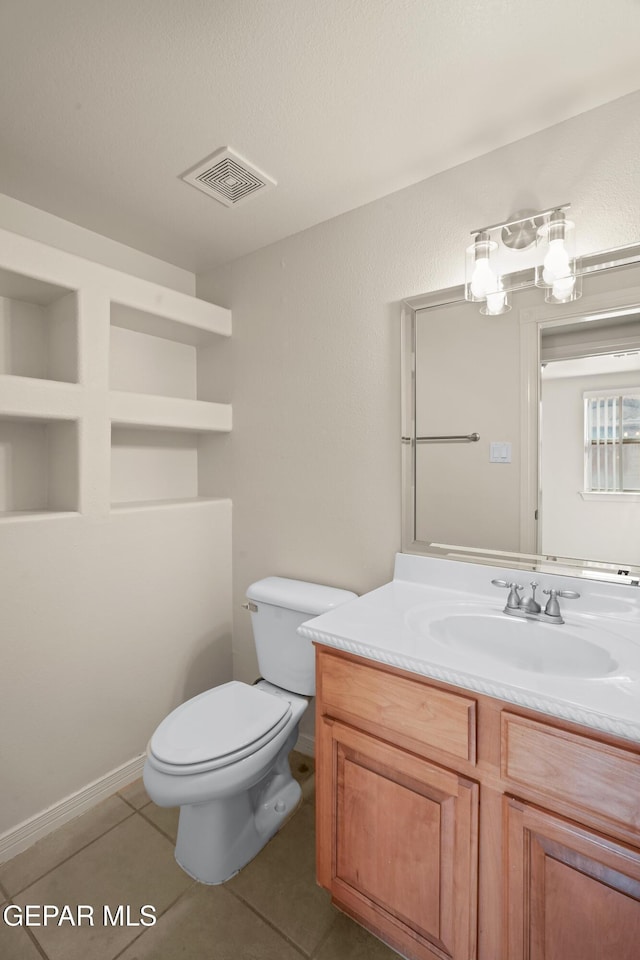 bathroom with vanity, tile patterned floors, toilet, and visible vents