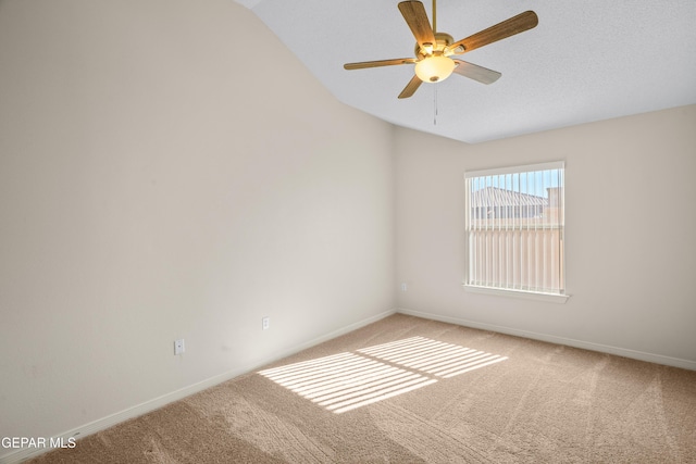 unfurnished room with light carpet, baseboards, ceiling fan, and vaulted ceiling