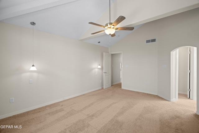 carpeted empty room featuring visible vents, high vaulted ceiling, a ceiling fan, arched walkways, and baseboards