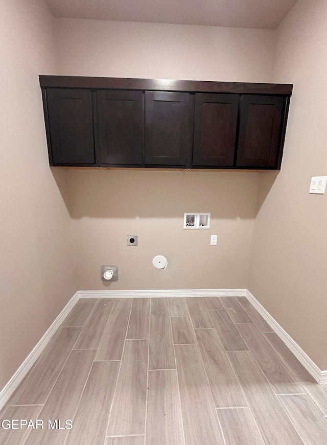 washroom featuring baseboards, wood tiled floor, hookup for a washing machine, cabinet space, and electric dryer hookup