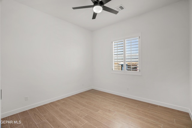 empty room with baseboards, visible vents, light wood finished floors, and ceiling fan