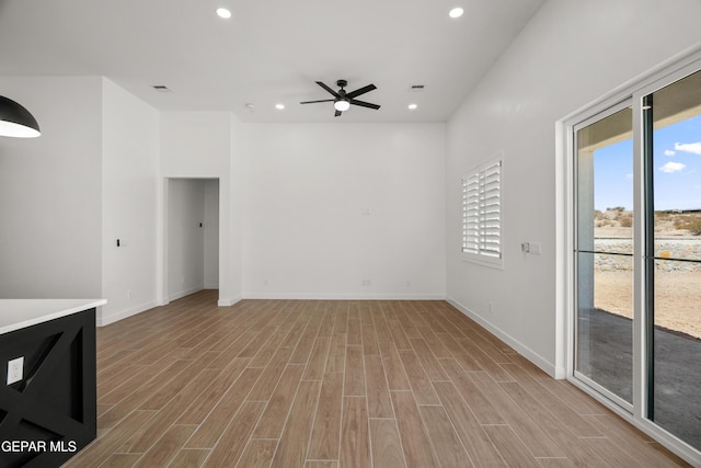 unfurnished living room featuring recessed lighting, baseboards, wood finished floors, and a ceiling fan