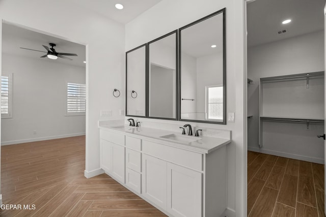 full bathroom featuring a sink, visible vents, a wealth of natural light, and a ceiling fan