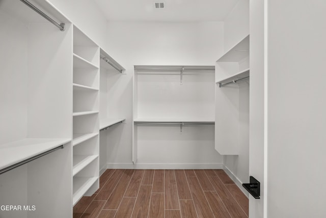 walk in closet featuring visible vents and wood tiled floor