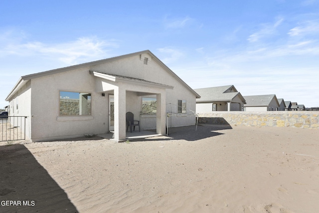 back of property featuring stucco siding and a patio