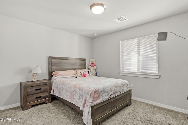 bedroom with light colored carpet, visible vents, and baseboards