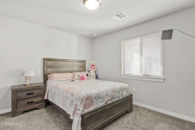 carpeted bedroom with visible vents and baseboards