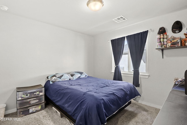 bedroom with visible vents, baseboards, and carpet