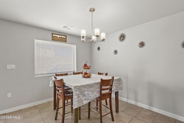 dining space featuring a chandelier, visible vents, baseboards, and light tile patterned flooring