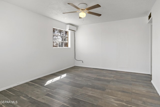 unfurnished room featuring wood finished floors, a ceiling fan, visible vents, a wall mounted AC, and a textured ceiling