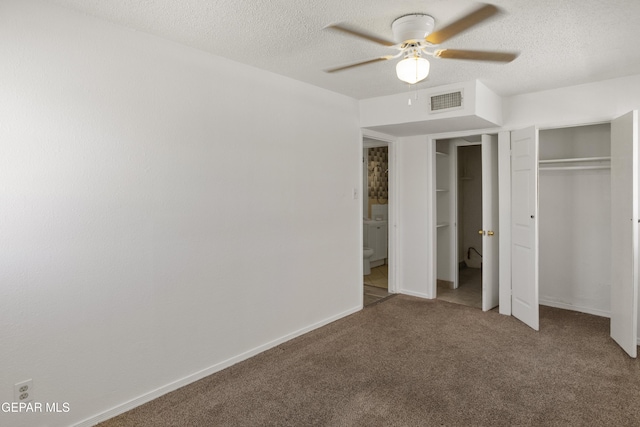 unfurnished bedroom featuring visible vents, baseboards, carpet flooring, a closet, and a textured ceiling