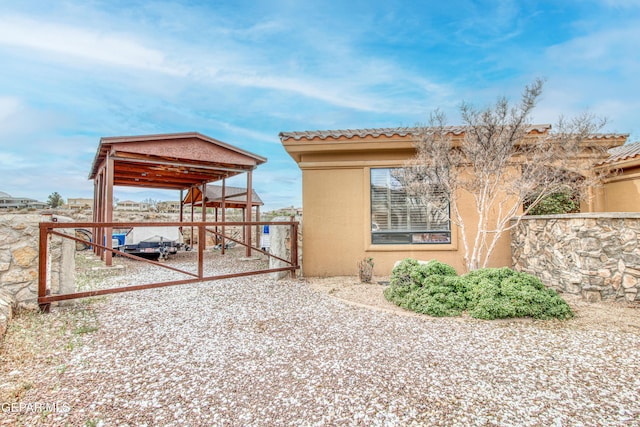 exterior space with a detached carport and driveway