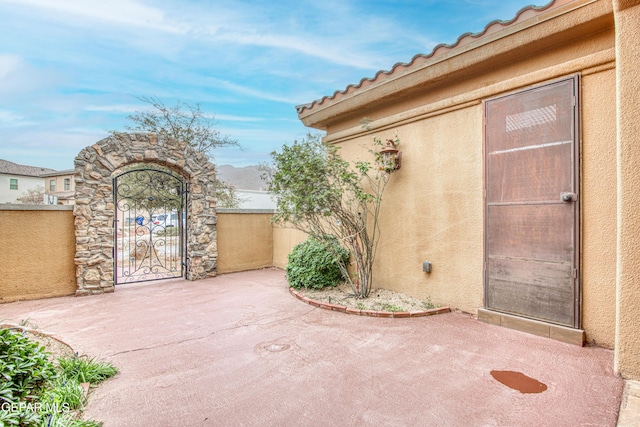 view of patio / terrace featuring a gate and fence