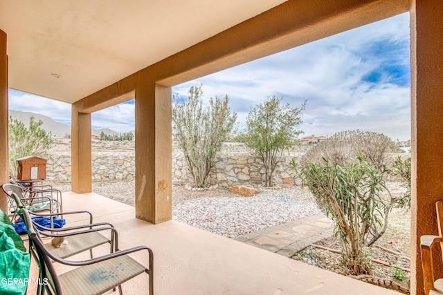 view of patio / terrace with a mountain view and a fenced backyard