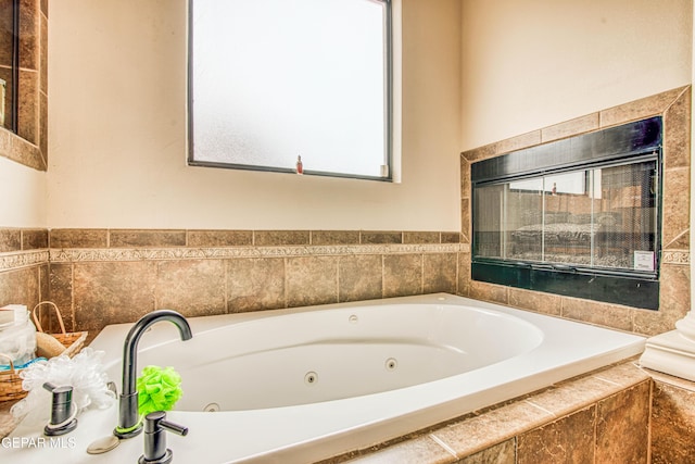 full bath featuring a wealth of natural light and a whirlpool tub