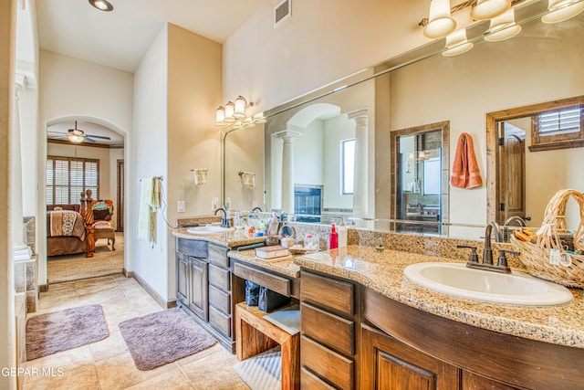 ensuite bathroom featuring visible vents, a ceiling fan, ensuite bath, decorative columns, and vanity