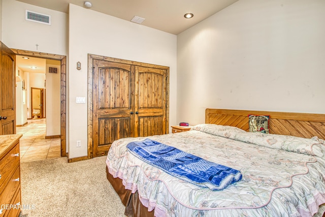 bedroom with visible vents, recessed lighting, light tile patterned flooring, baseboards, and light colored carpet