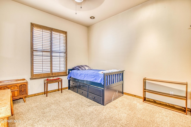 carpeted bedroom with baseboards and a ceiling fan