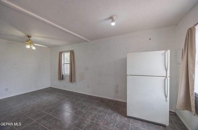 spare room with baseboards, ceiling fan, and tile patterned flooring