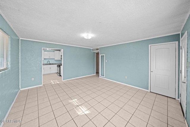 unfurnished room featuring visible vents, a sink, a textured ceiling, crown molding, and baseboards