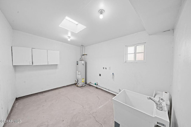 washroom with water heater, a skylight, and a sink