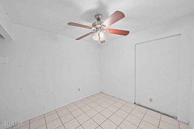 unfurnished room featuring light tile patterned flooring and a ceiling fan