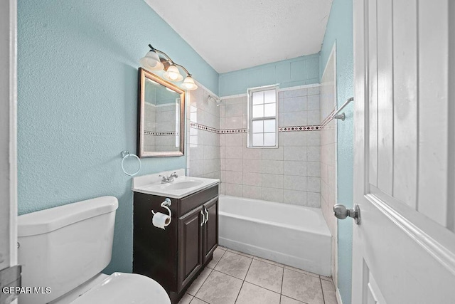 full bath with tile patterned flooring, toilet, vanity, and a textured wall