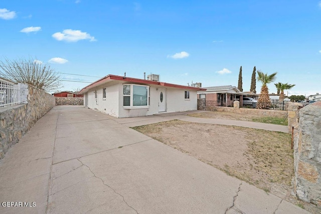 view of front of house featuring driveway and fence