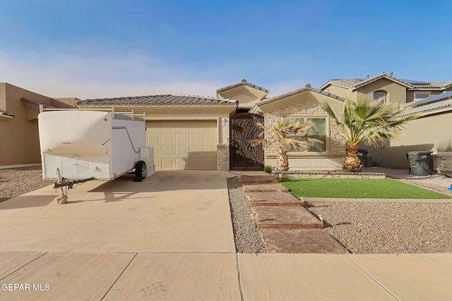 view of front of property featuring a tile roof, an attached garage, driveway, and stucco siding