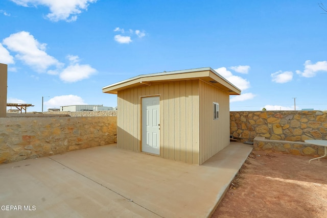 view of shed with fence