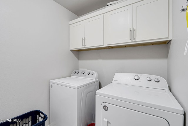 laundry room featuring cabinet space and washer and clothes dryer