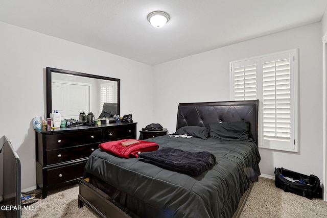 carpeted bedroom with baseboards