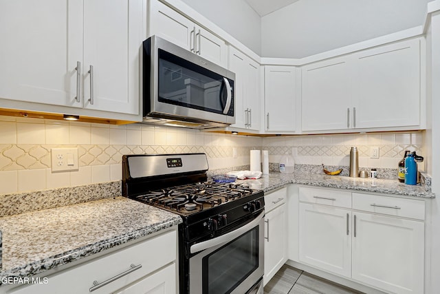 kitchen featuring white cabinetry, tasteful backsplash, and stainless steel appliances