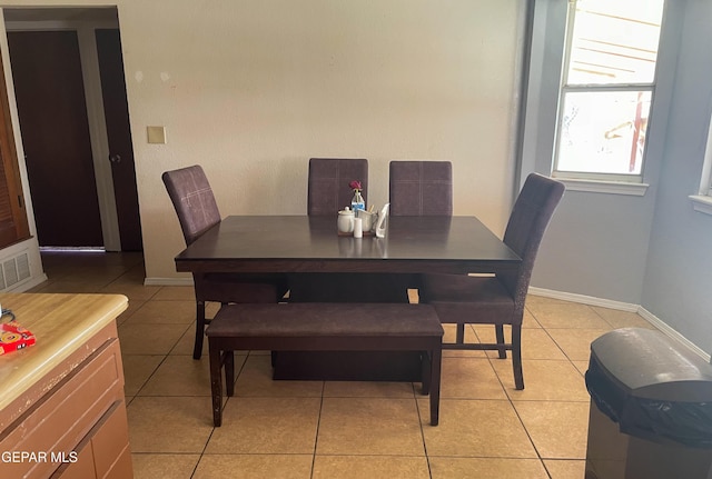 dining space with light tile patterned floors and baseboards