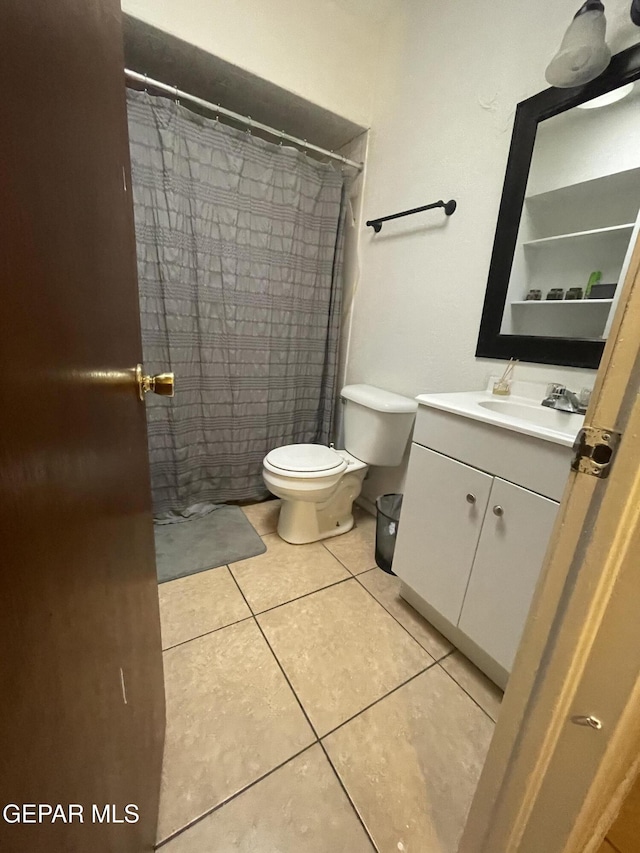 full bathroom featuring vanity, tile patterned floors, toilet, and a shower with curtain