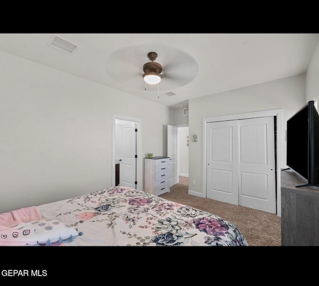 bedroom featuring visible vents, carpet floors, a closet, and a ceiling fan