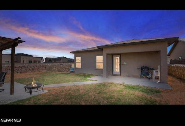 rear view of house featuring a fire pit, fence, a yard, a patio area, and a pergola