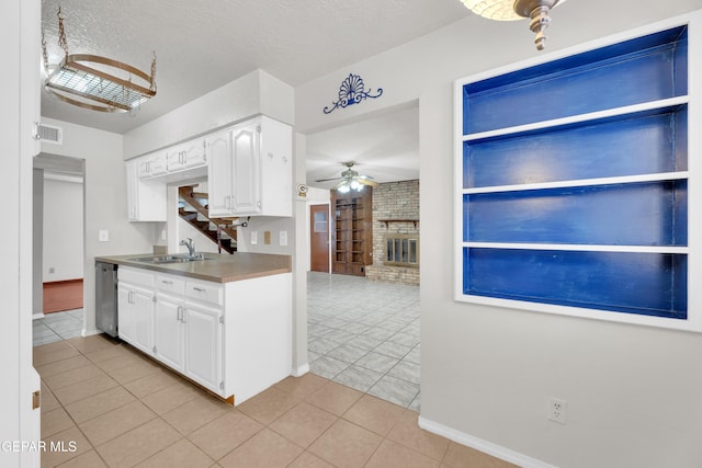 kitchen featuring visible vents, a ceiling fan, a sink, white cabinetry, and dishwasher