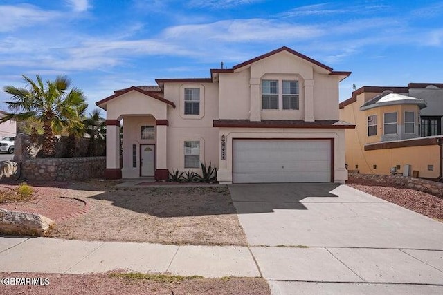 view of front of property featuring stucco siding, an attached garage, and concrete driveway