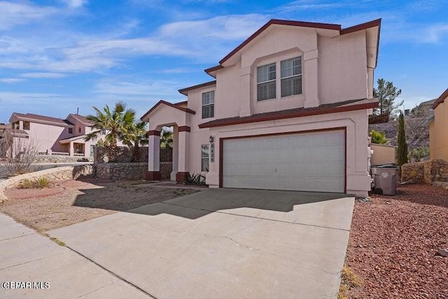 view of front of home featuring stucco siding, an attached garage, and concrete driveway