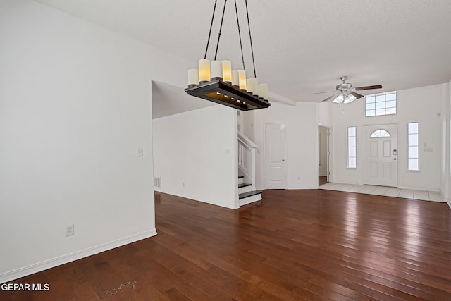 entrance foyer featuring ceiling fan, baseboards, hardwood / wood-style floors, and stairs