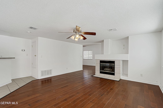 unfurnished living room with visible vents and hardwood / wood-style flooring