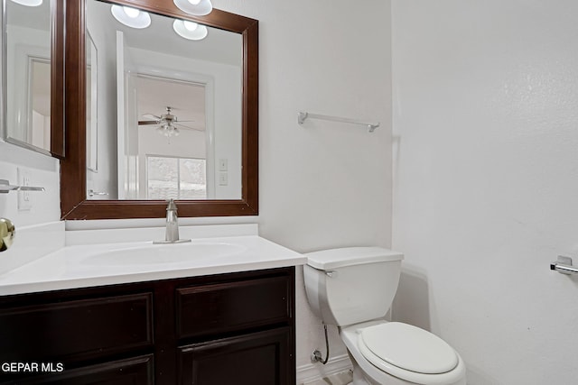 bathroom featuring vanity, toilet, and ceiling fan