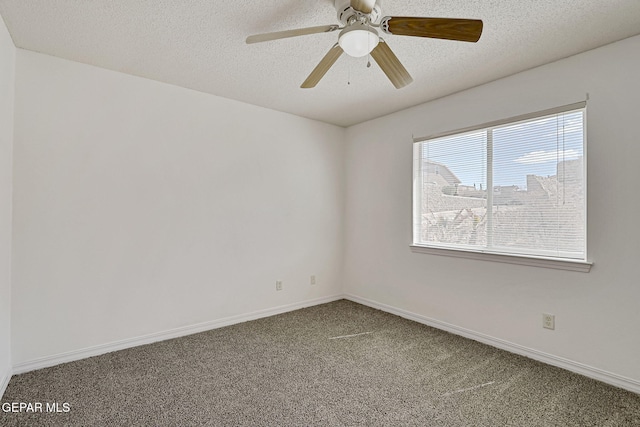 empty room featuring carpet flooring, ceiling fan, a textured ceiling, and baseboards