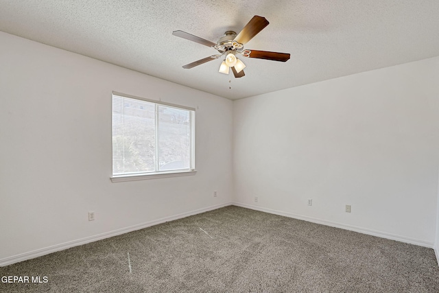 spare room featuring baseboards, a textured ceiling, carpet, and a ceiling fan